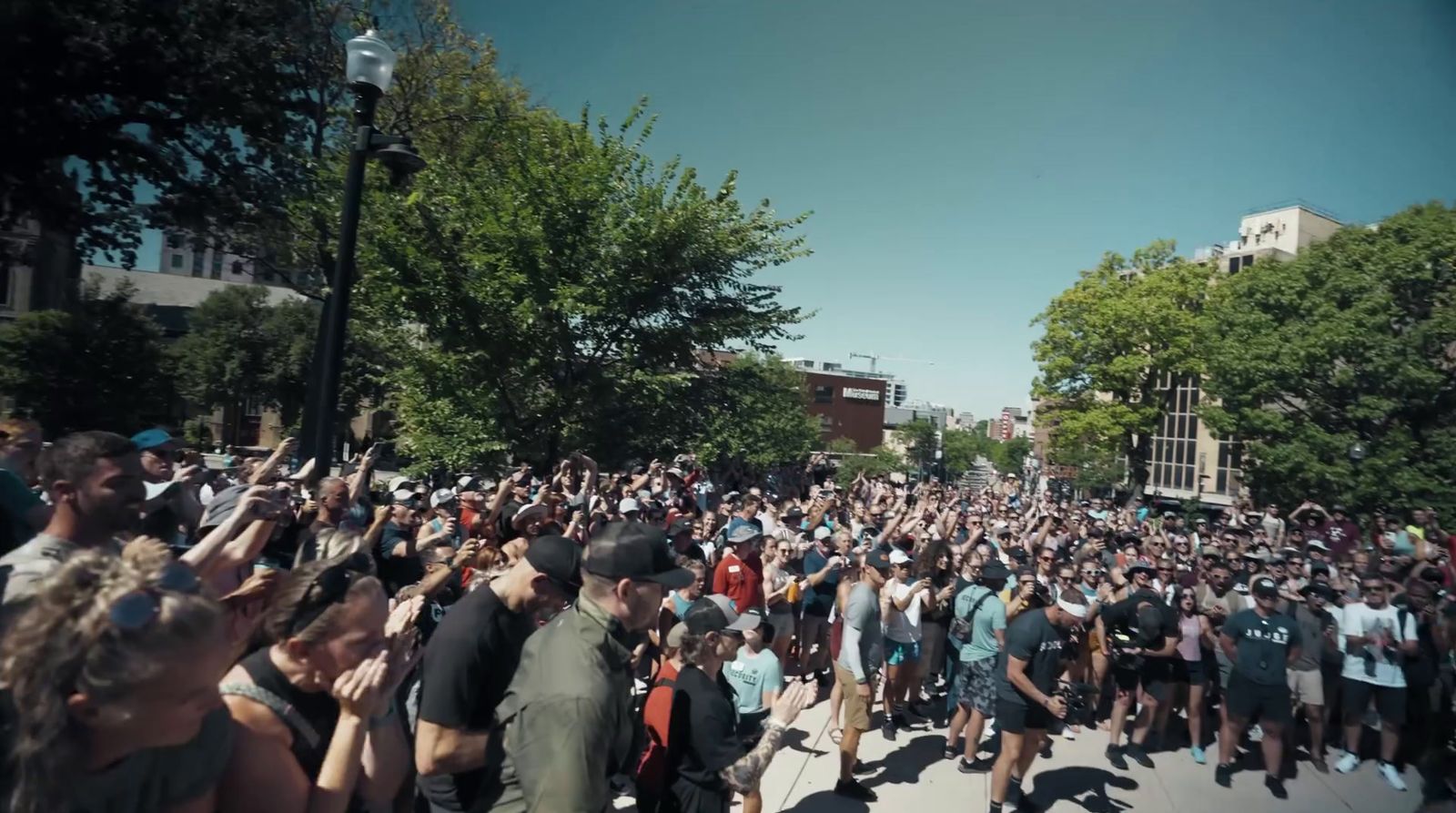 a large crowd of people walking down a street