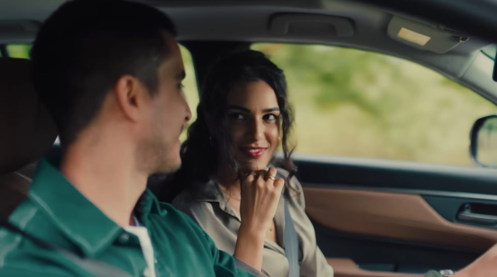 a man and a woman sitting in a car