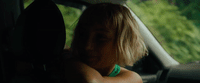 a woman sitting in the passenger seat of a car