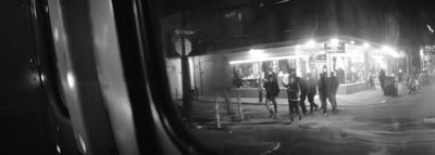 a group of people standing outside of a building at night