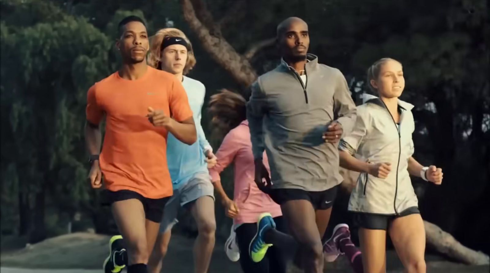 a group of people running down a street