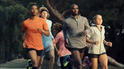 a group of people running down a street