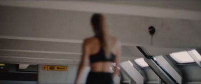 a blurry photo of a woman in a black sports bra