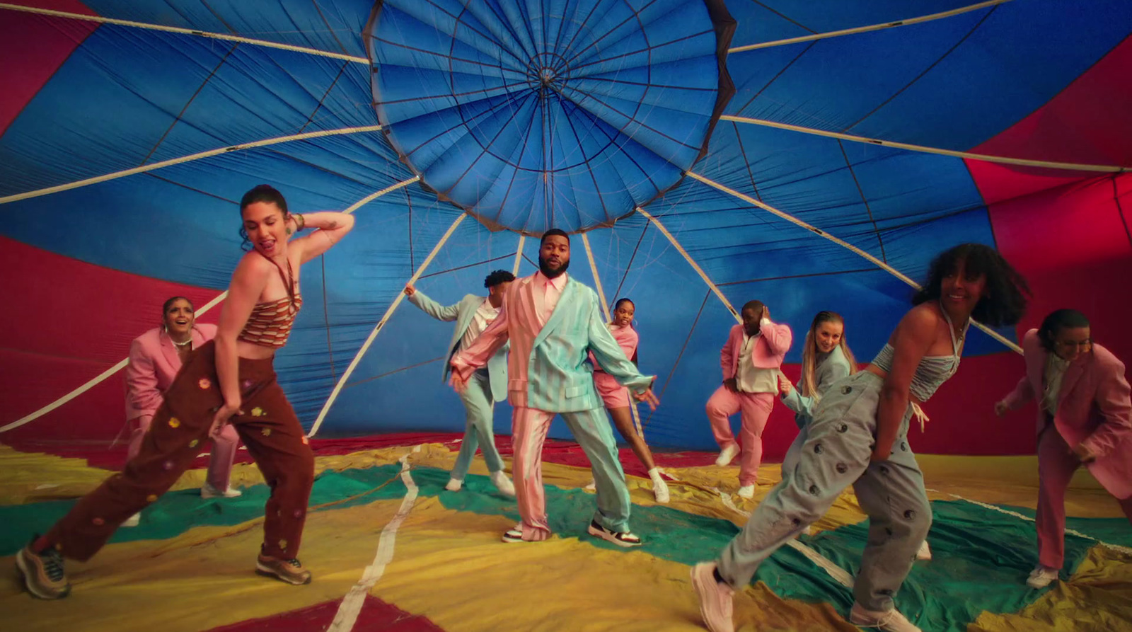 a group of people standing around a hot air balloon