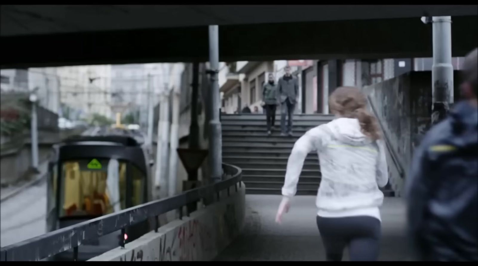 a woman walking down a set of stairs