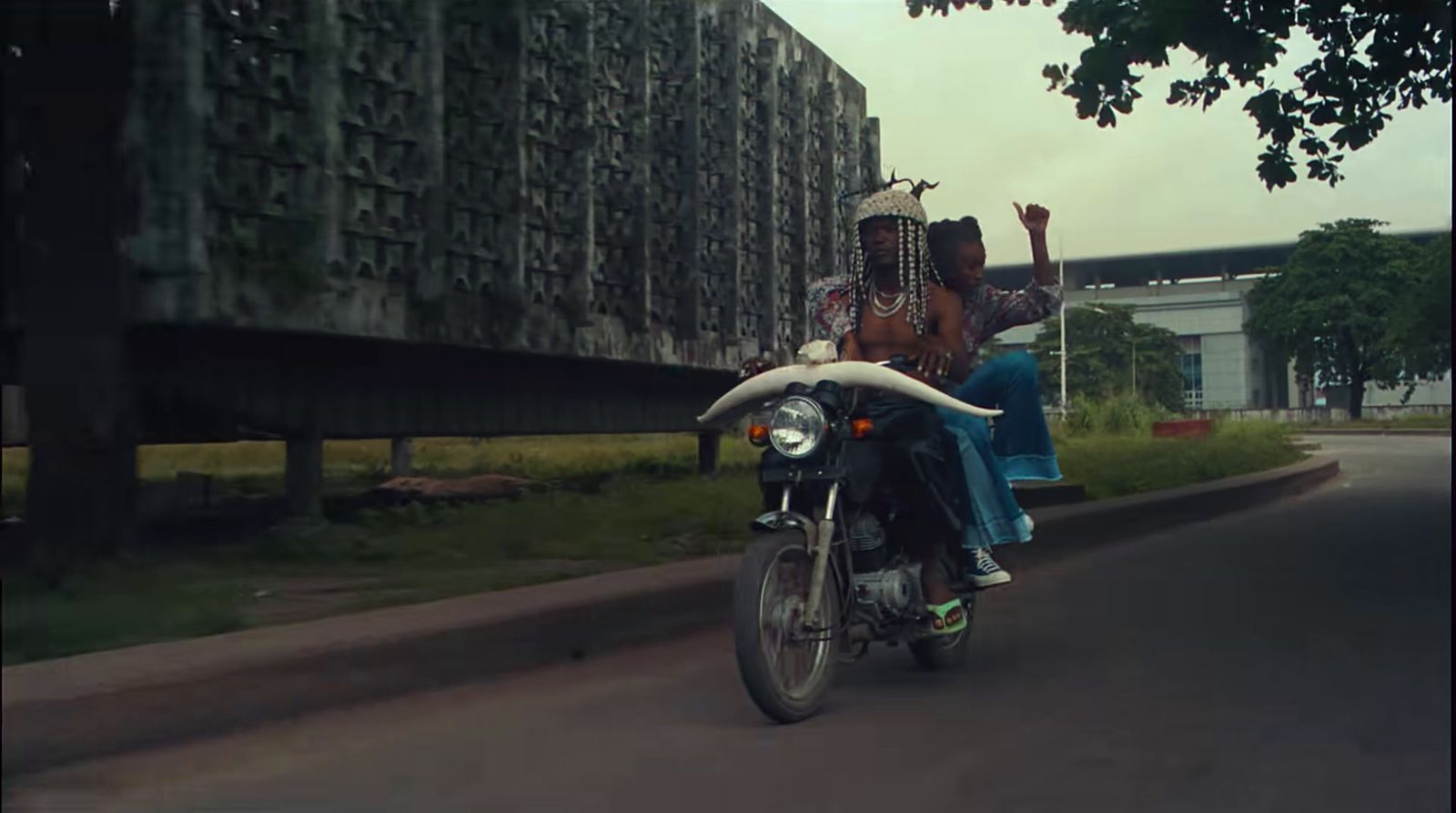 a couple of people riding on the back of a motorcycle