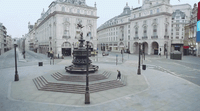 a city square with a fountain in the middle of it