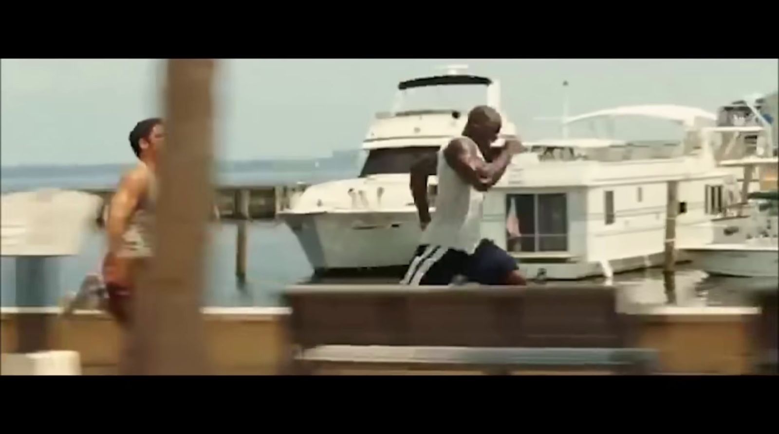 a man standing on top of a dock next to a boat