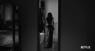 a woman standing in front of a mirror in a room