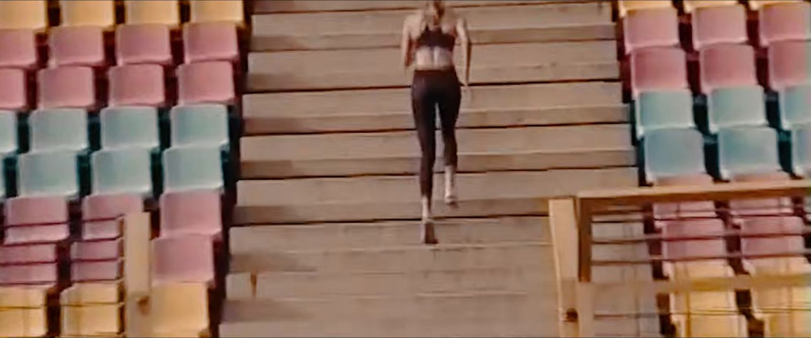 a woman is walking down a flight of stairs