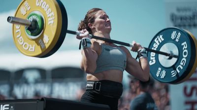 a woman holding a barbell in her hands