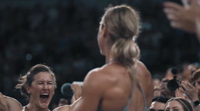 a group of women standing next to each other in front of a crowd