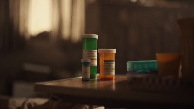 a table topped with three bottles of medicine