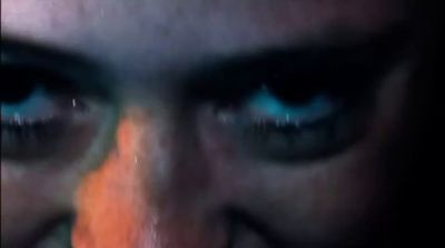 a close up of a person's face with blue eyes