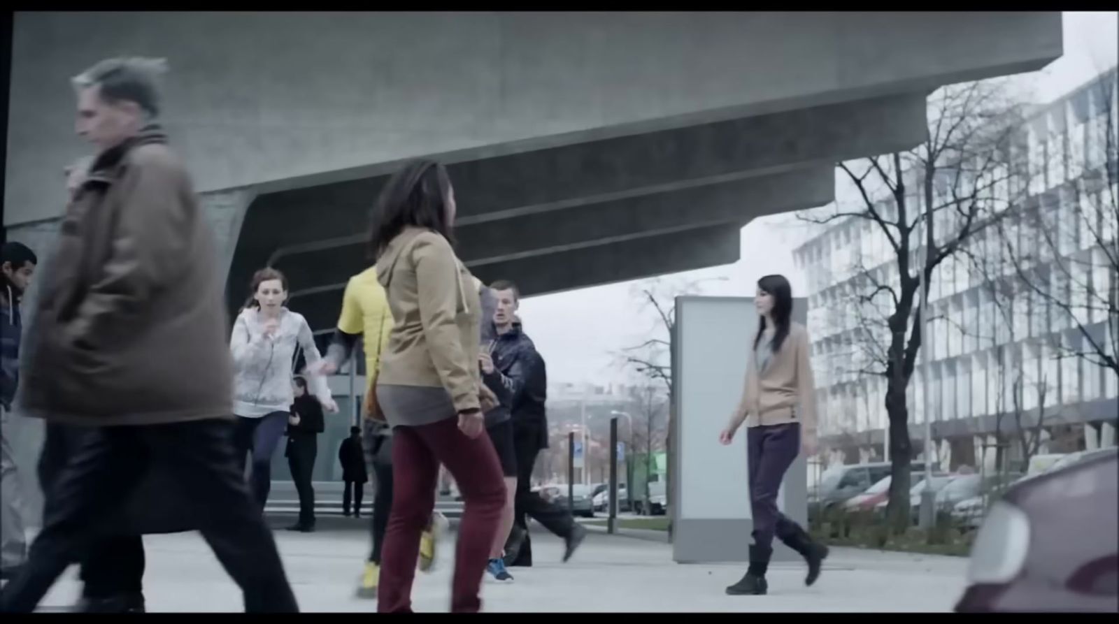 a group of people walking down a sidewalk