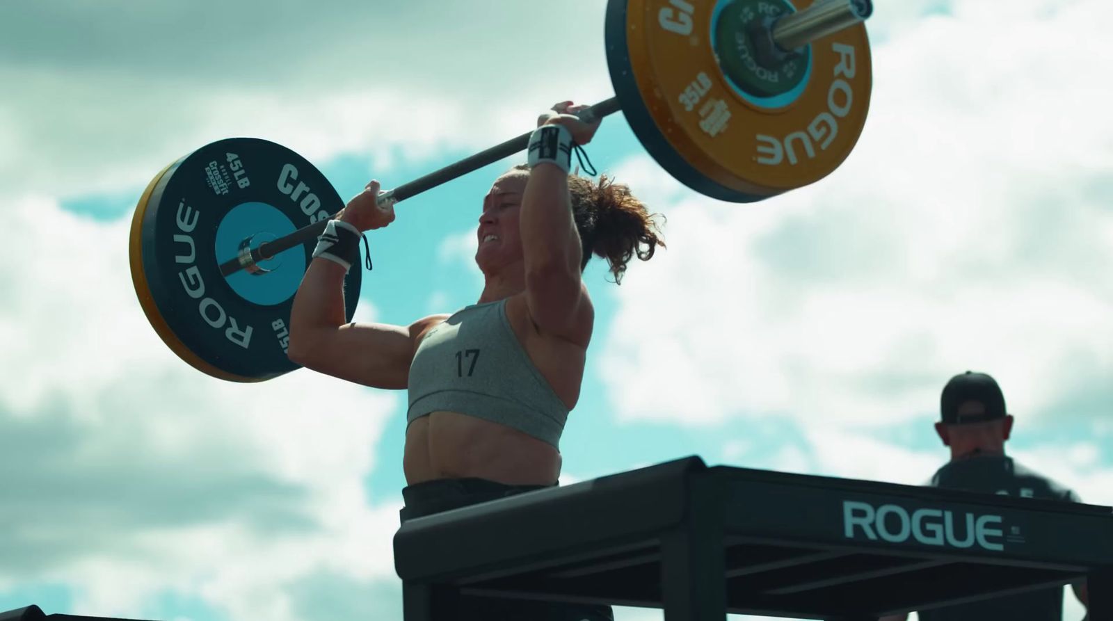 a woman holding a barbell above her head