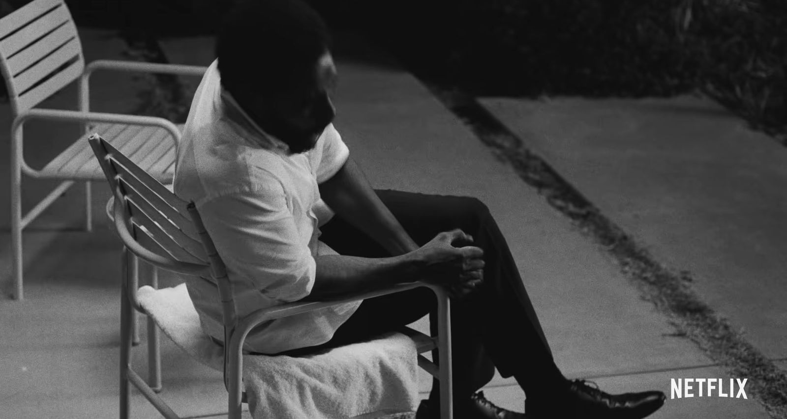 a man sitting in a chair with his feet crossed