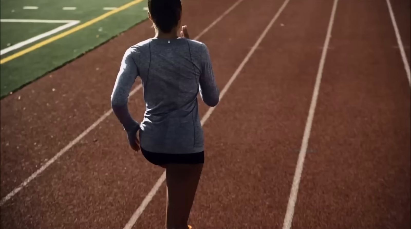 a woman running on a running track