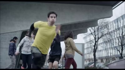 a man in a yellow shirt is playing with a frisbee