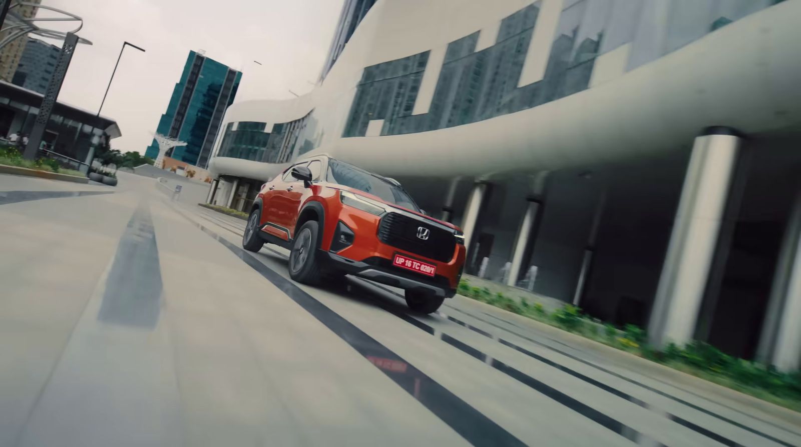 a red suv driving down a city street