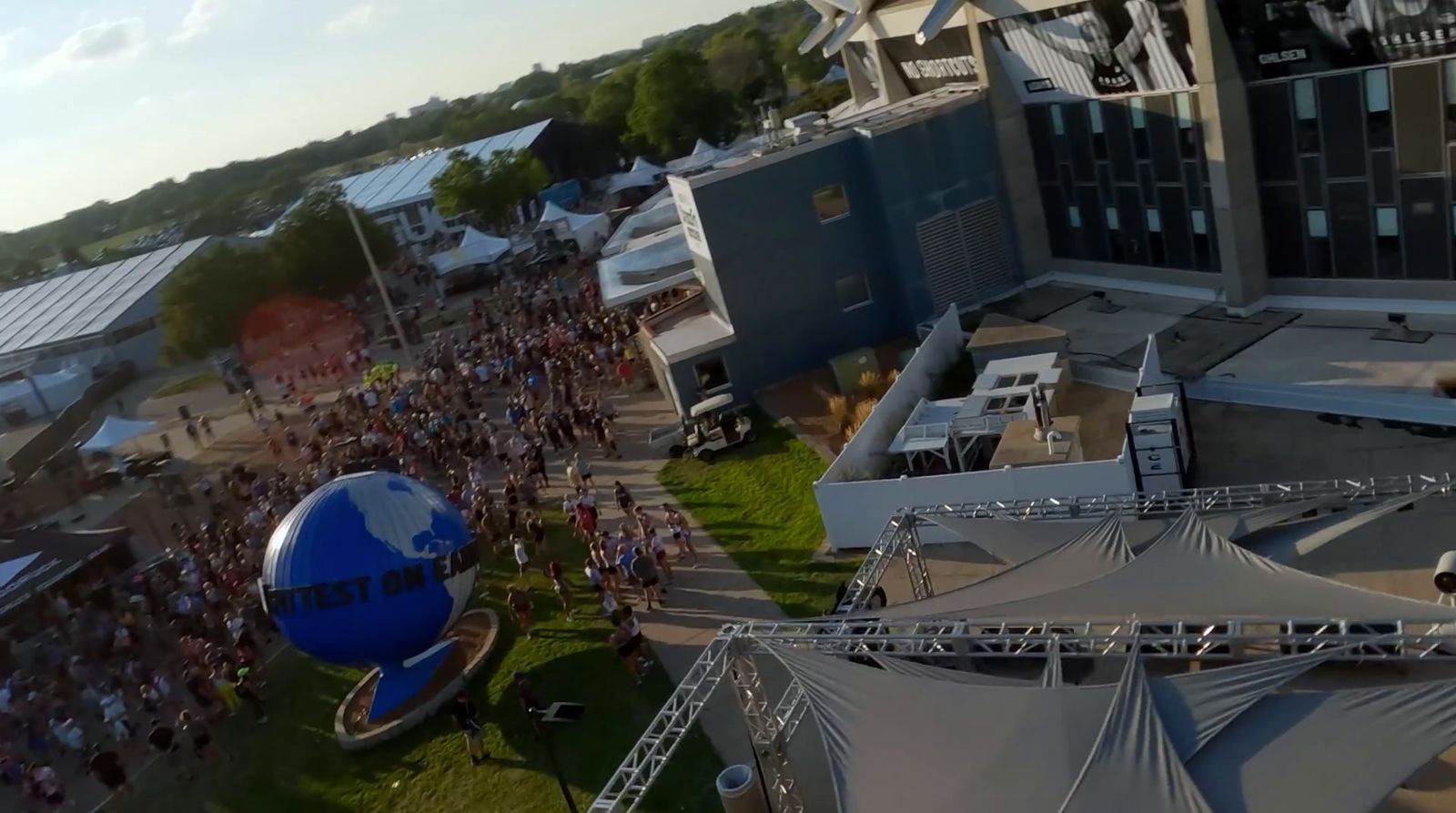 a crowd of people standing around a giant blue ball