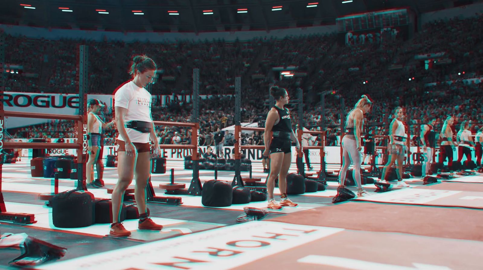 a group of men standing on top of a wrestling ring