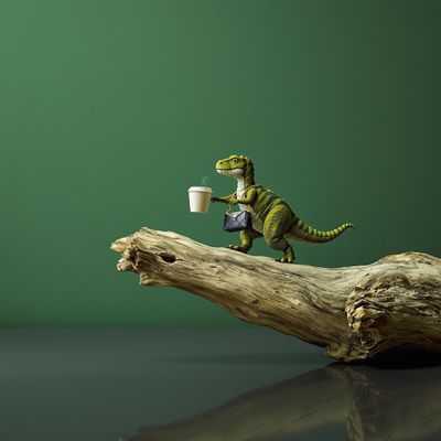 a small toy dinosaur holding a cup of coffee