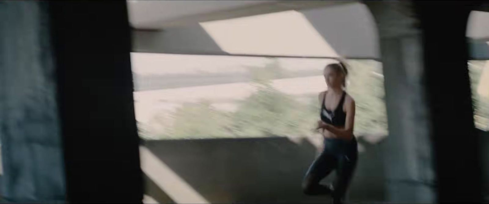 a blurry image of a woman in a tank top