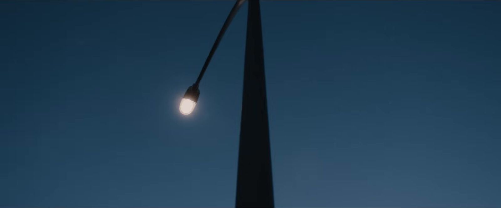 a street light on a pole with a blue sky in the background