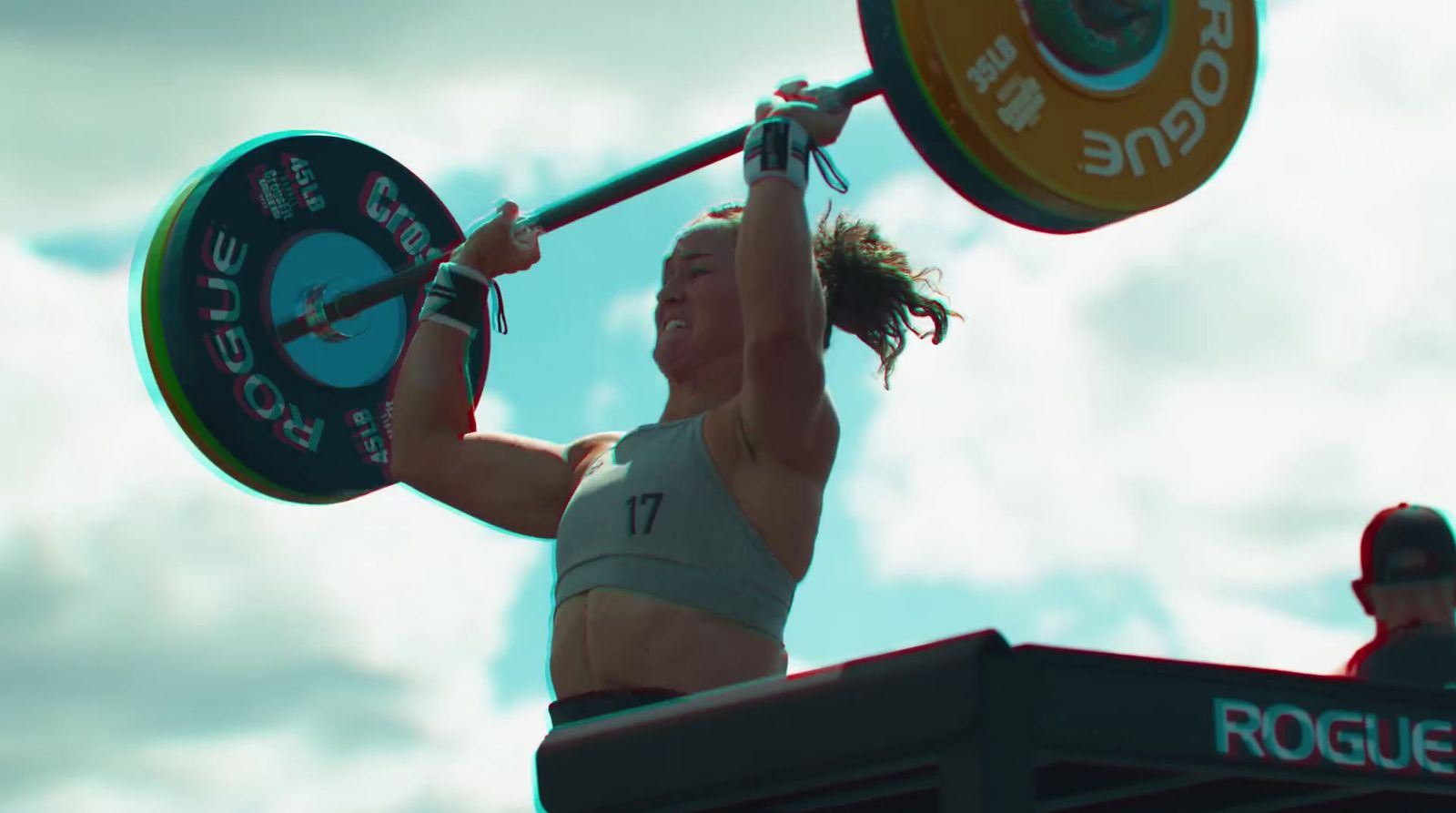 a woman holding a barbell above her head