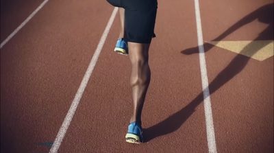 a woman is running on a running track