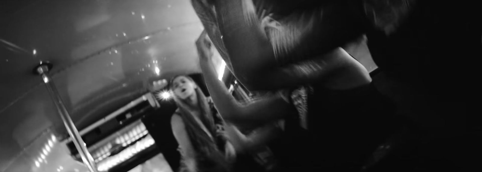 a black and white photo of a woman on a bus