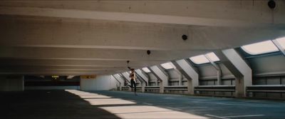 a person riding a bike in a parking garage