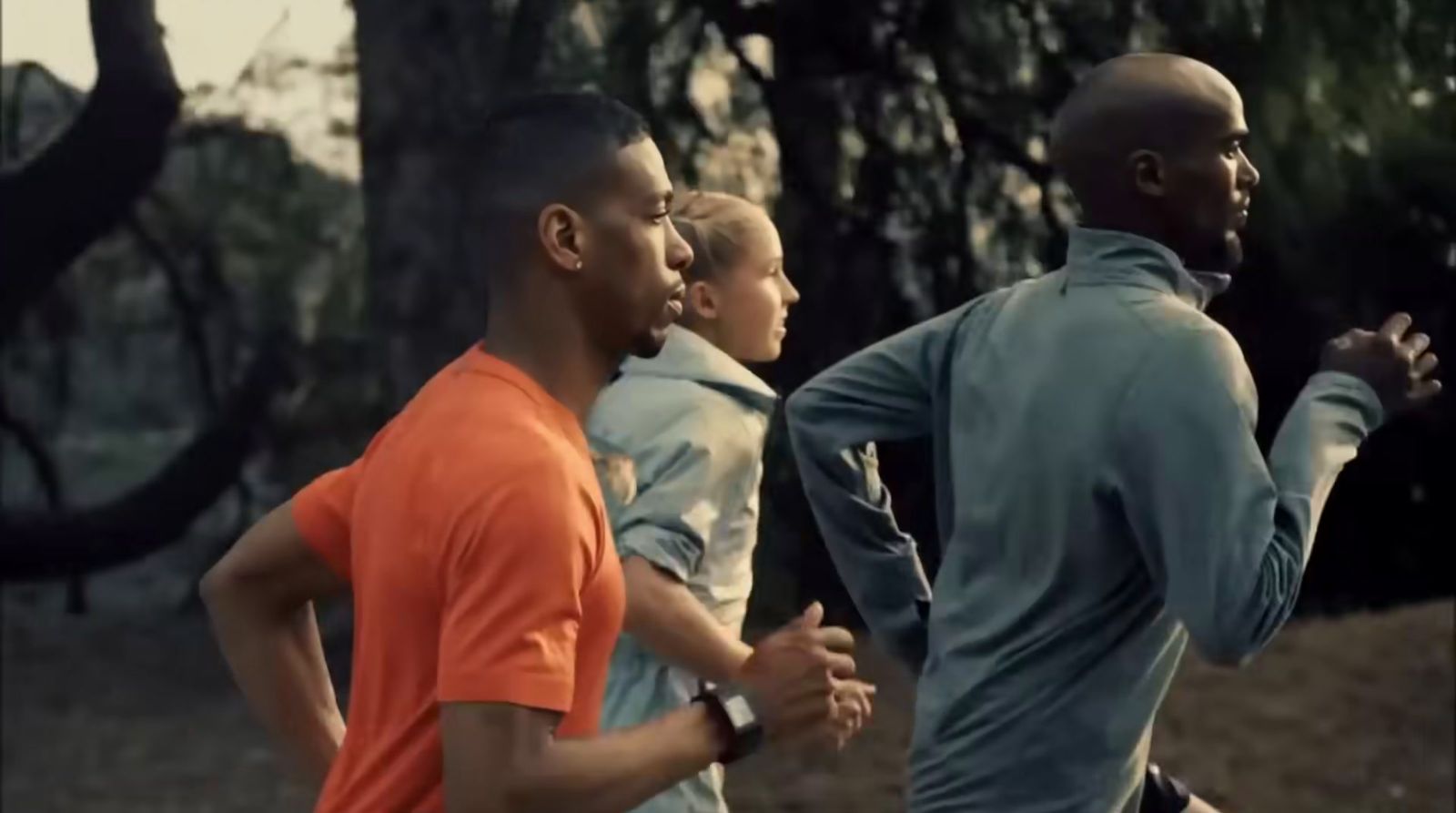 a group of people running in a park