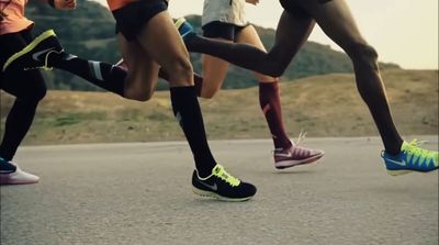 a group of people running down a road