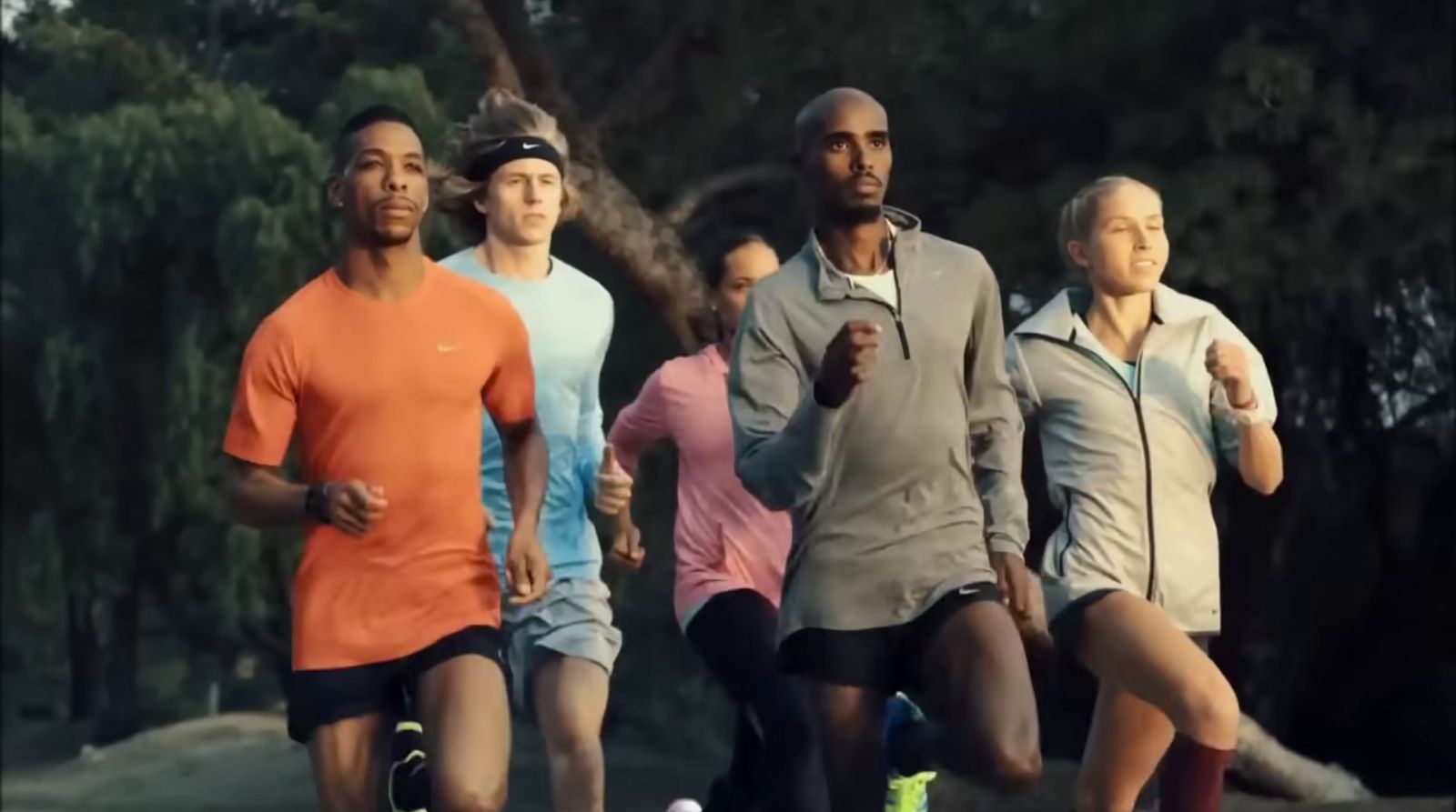 a group of people running in a park