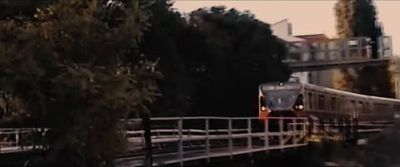 a train traveling over a bridge next to a forest