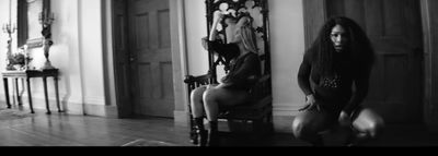 a black and white photo of a woman sitting in a chair