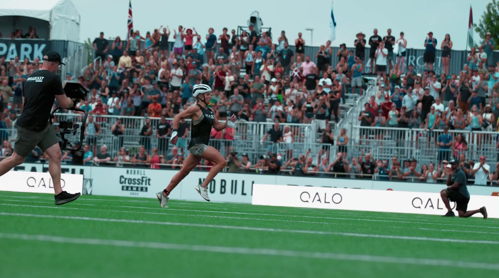 a couple of people that are running on a field