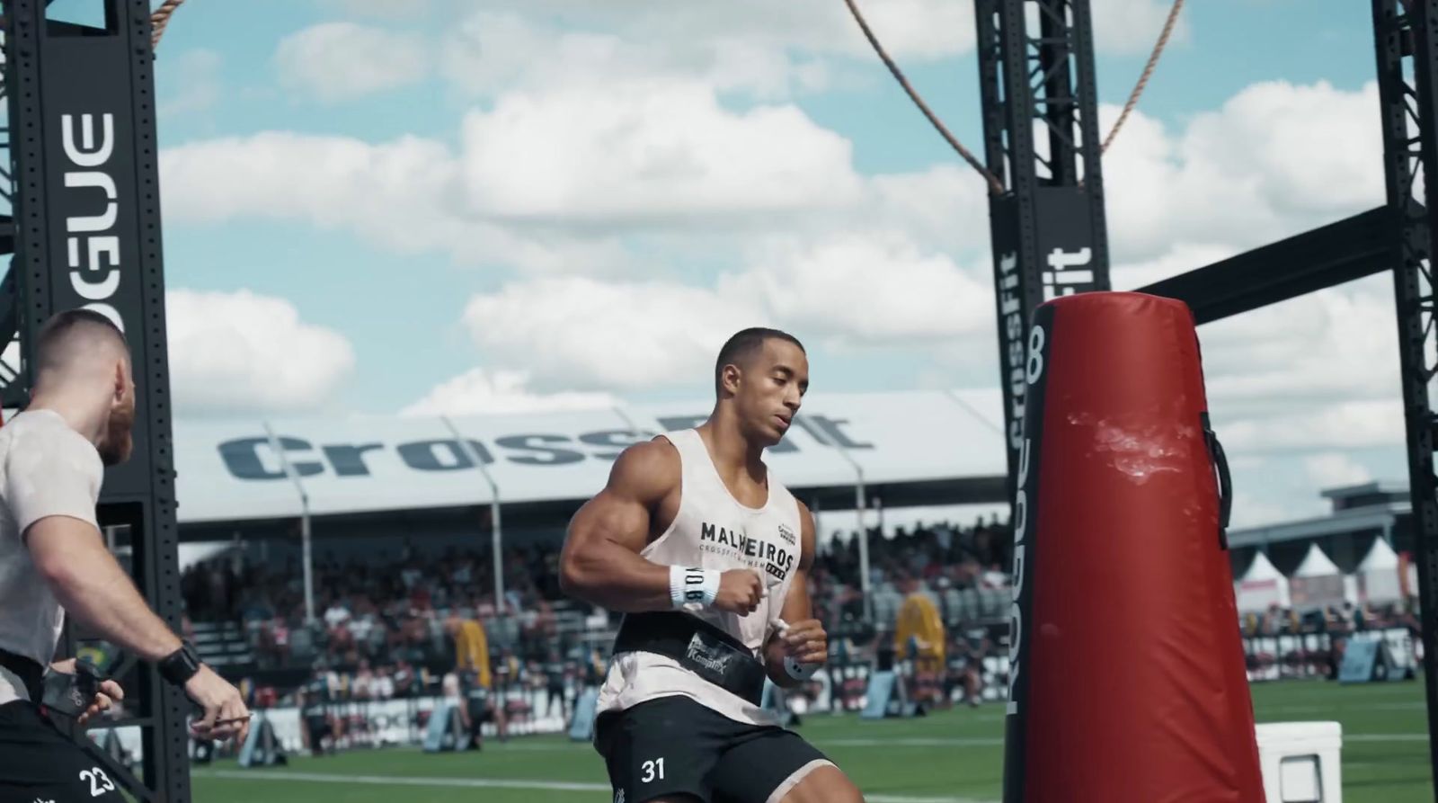 a man is running in a crossfit competition