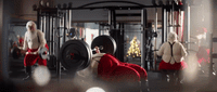 a man in a santa suit doing squats with a barbell