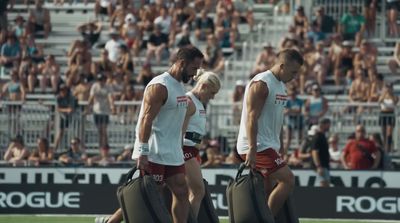 a group of men walking across a soccer field