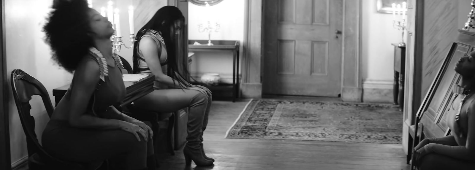 a black and white photo of a woman sitting in a chair