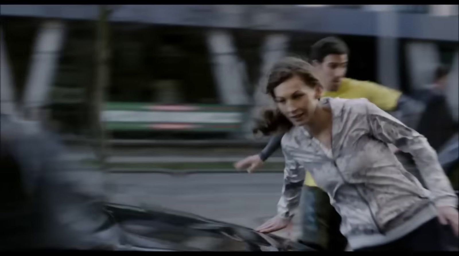 a blurry image of a woman running with a car