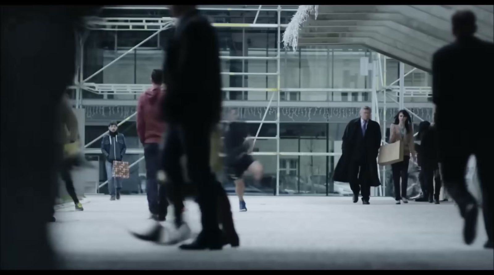 a group of people walking around a building