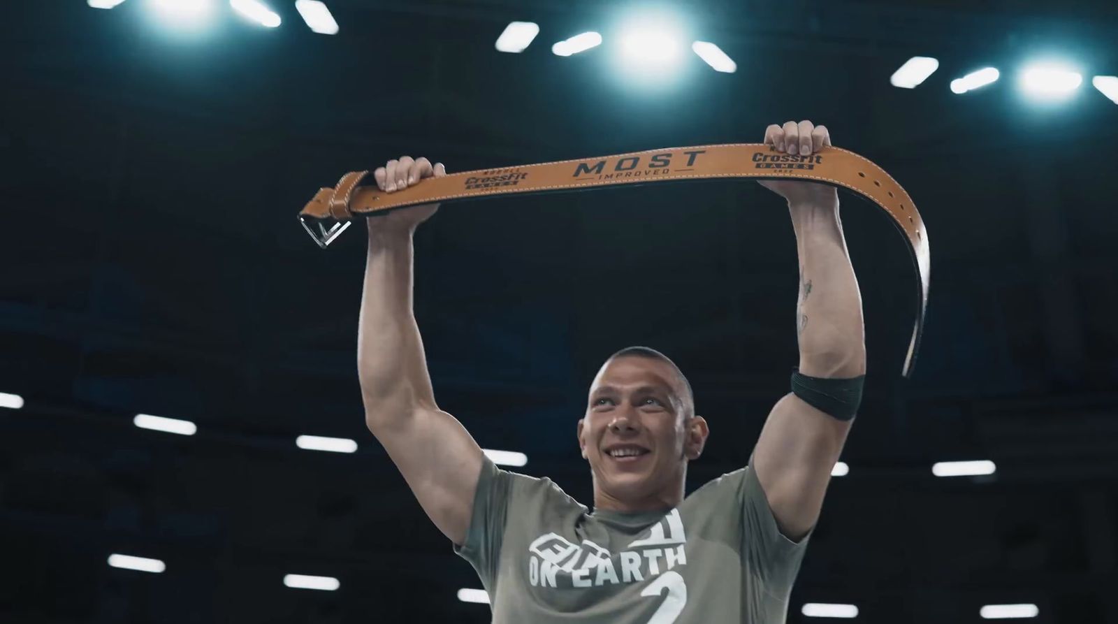 a man holding up a trophy in front of a crowd