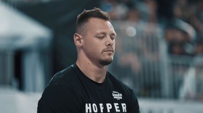 a man with his eyes closed standing in front of a crowd