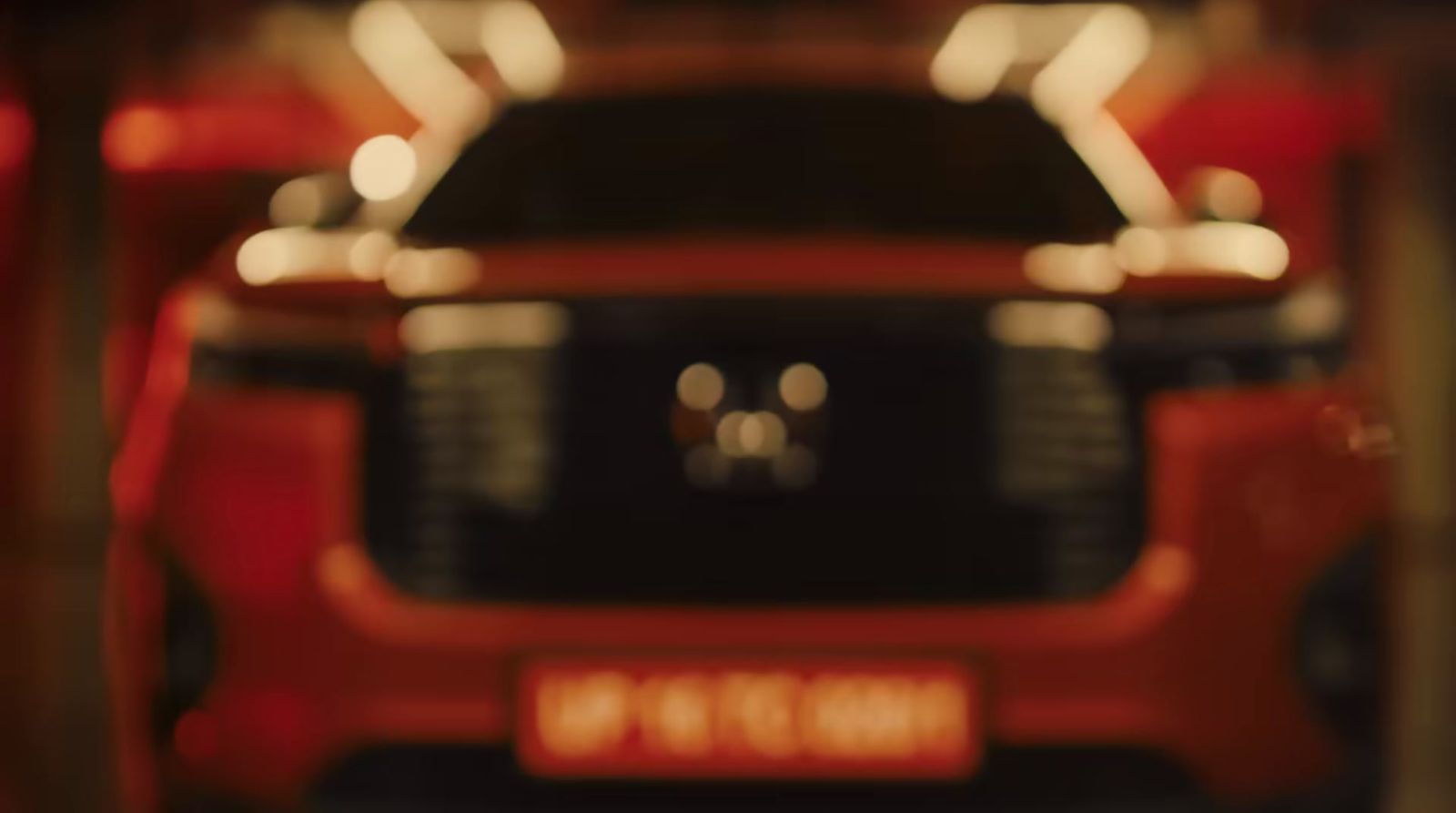 a close up of a red car in a garage