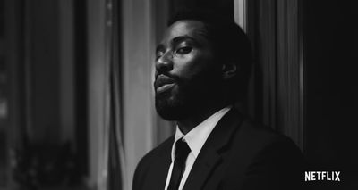 a black and white photo of a man in a suit