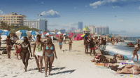 a group of people walking on a beach next to the ocean